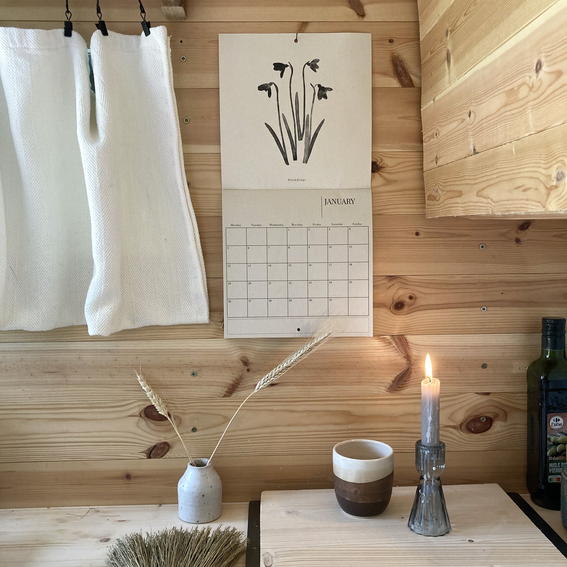 Calendar on a wooden wall with a table in the foreground