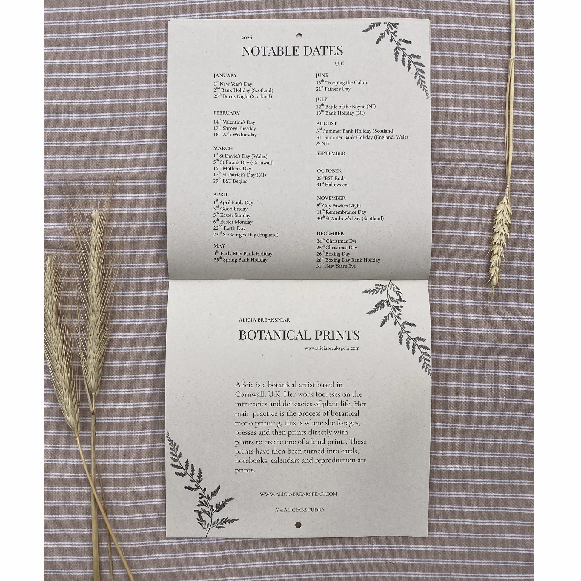 Sheet of paper with 'Notable Dates' and 'Botanical Prints' text on a textured background with wheat stalks.