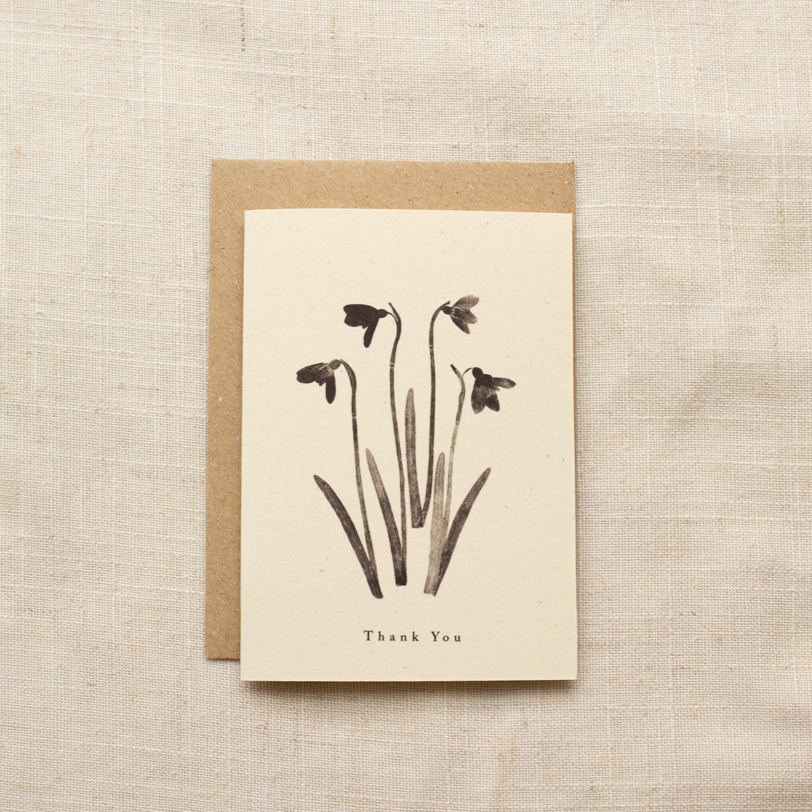 Greeting card with floral design and 'Thank You' text on a textured beige background