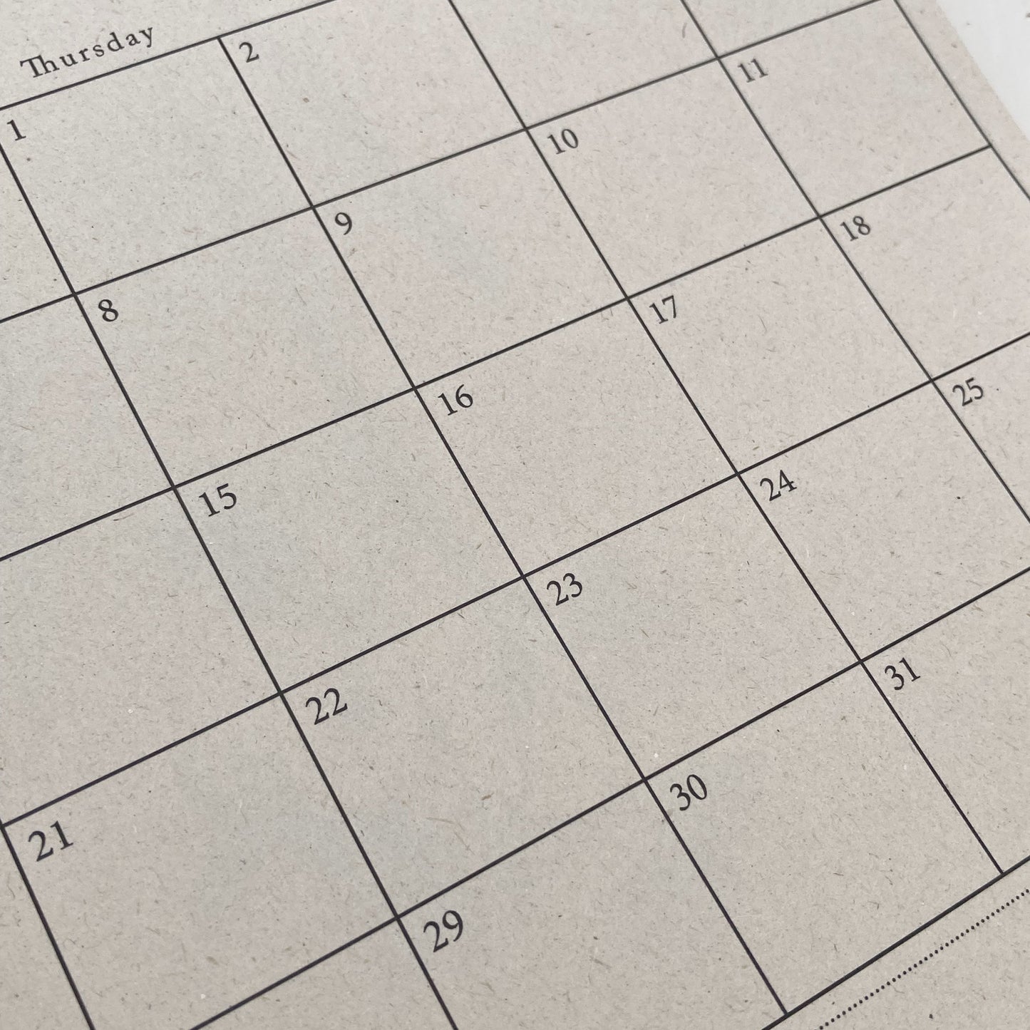 Calendar grid on a textured beige background