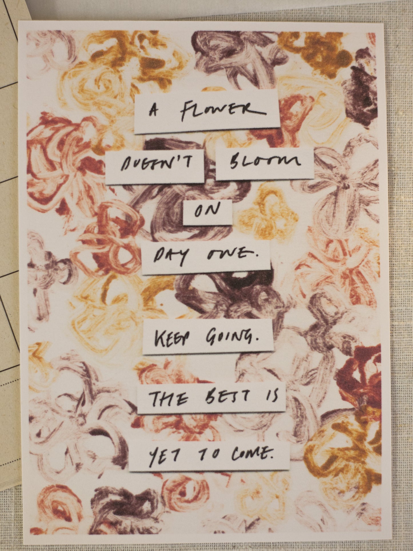 Motivational poster with floral design and inspirational text on a printed surface.