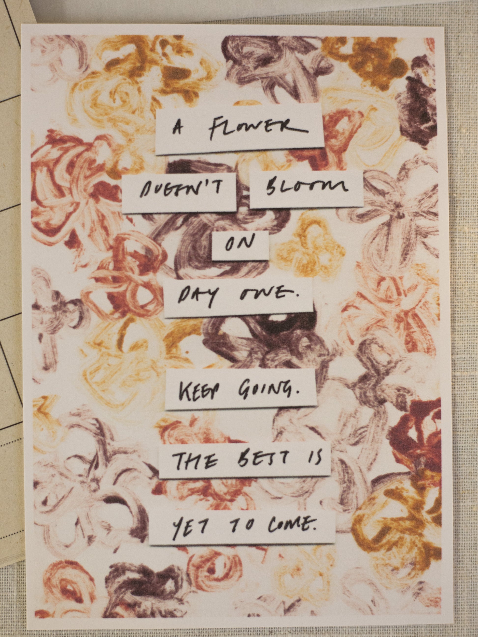 Motivational poster with floral design and inspirational text on a printed surface.