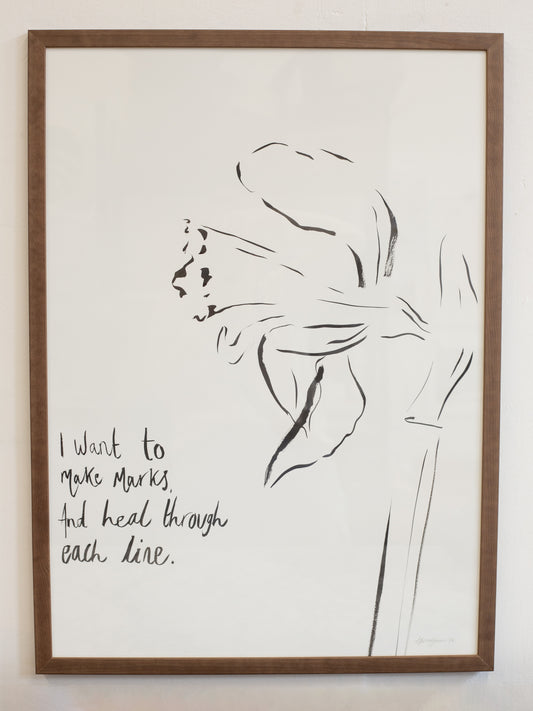 Framed artwork with a black line drawing of a flower and text on a white background