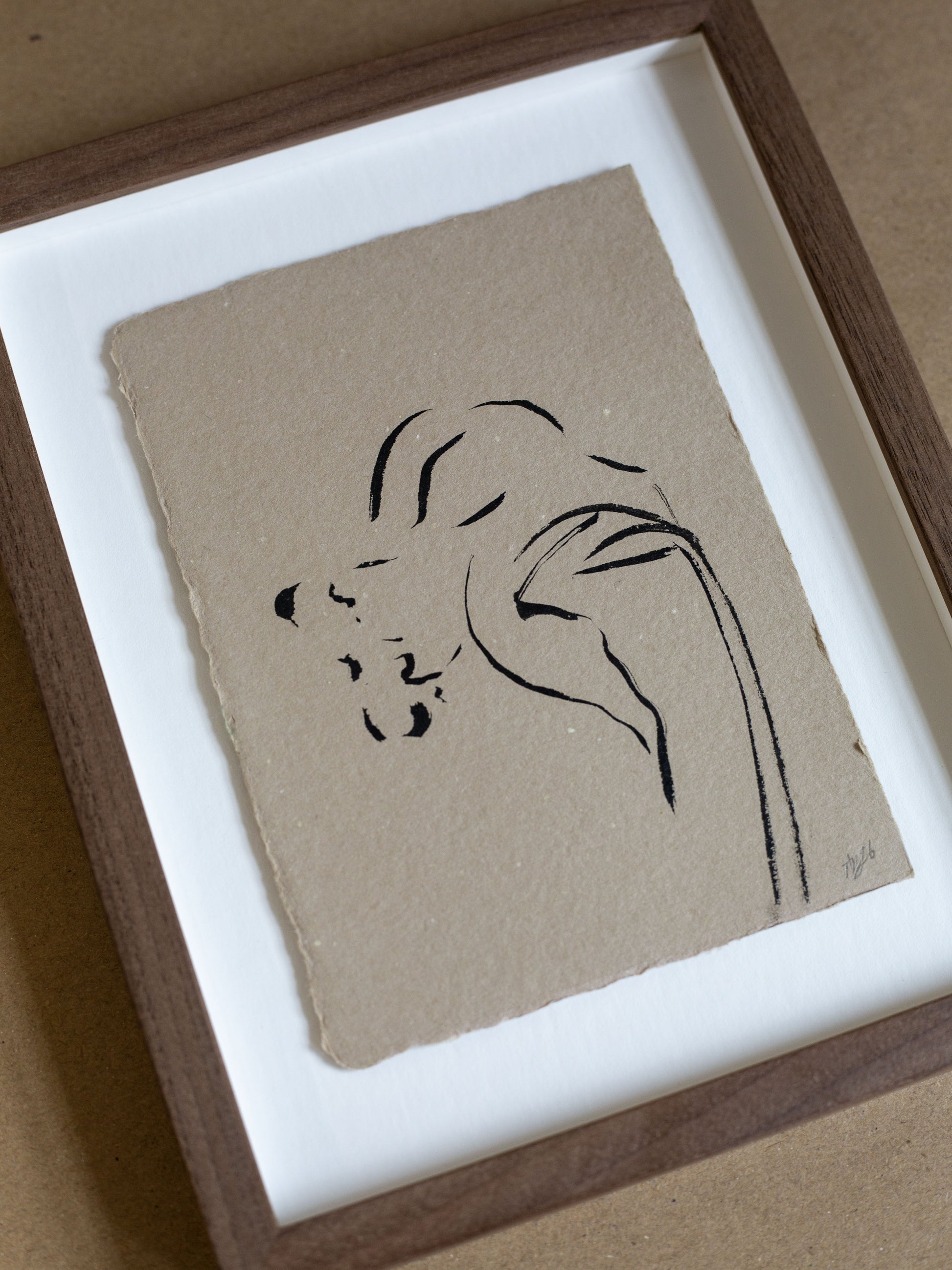 Framed minimalist line drawing of a daffodil on beige paper