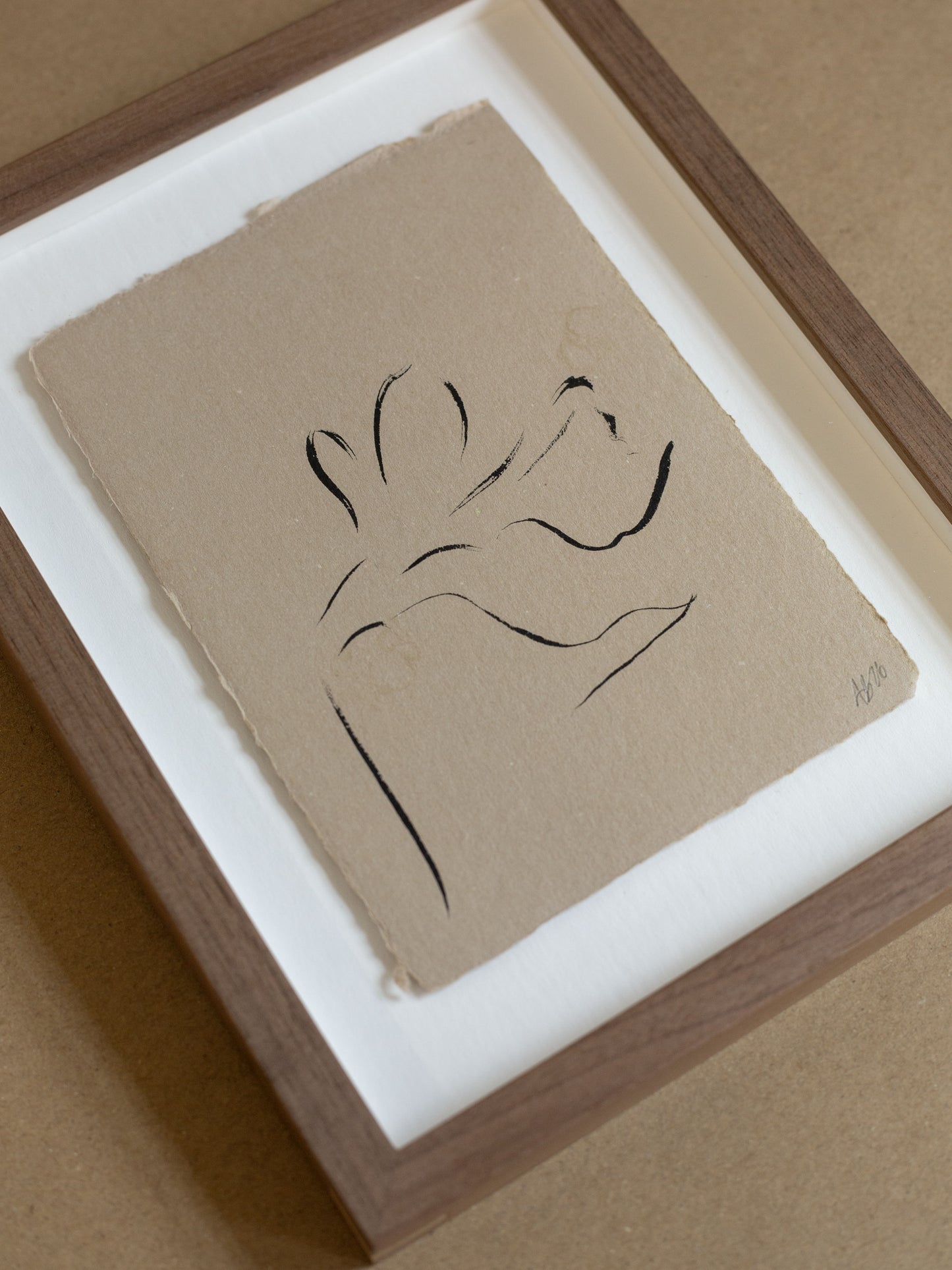 Framed minimalist line art of a daffodil on brown paper