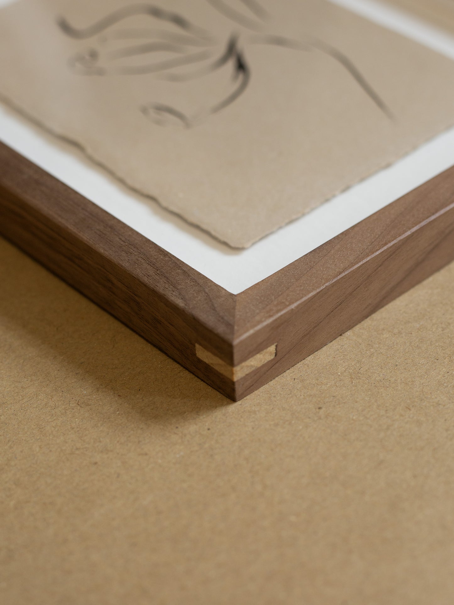 Wooden frame with a textured beige panel on a matching brown surface