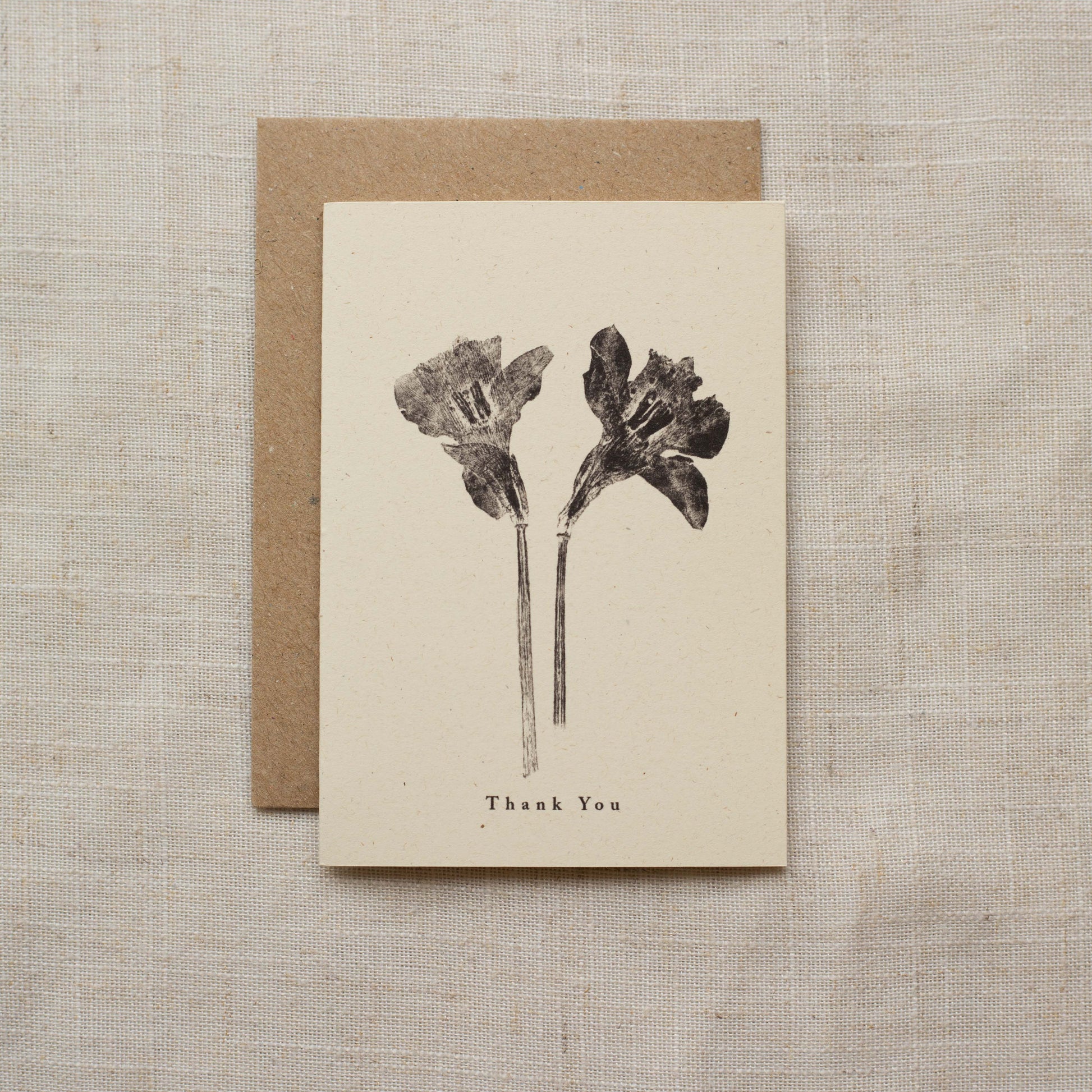 Greeting card with floral design and 'Thank You' text on a matte surface
