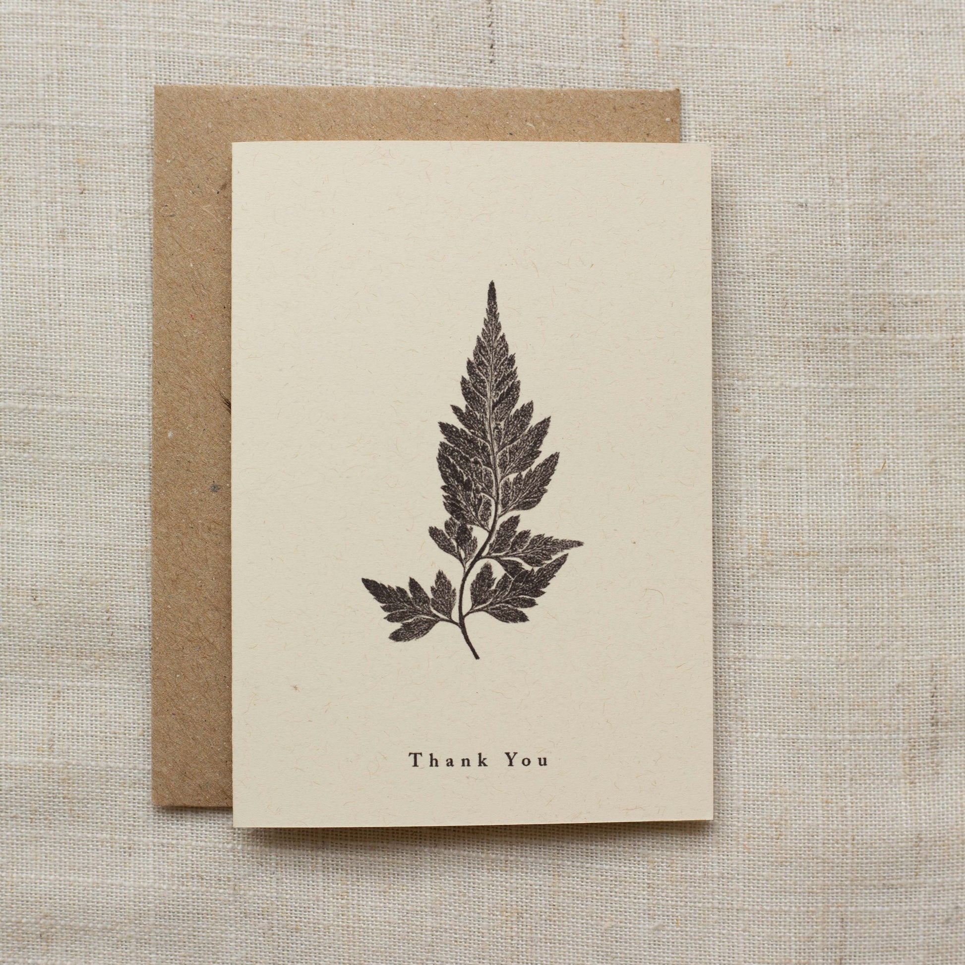 Greeting card with fern design and 'Thank You' text on a matte beige backround