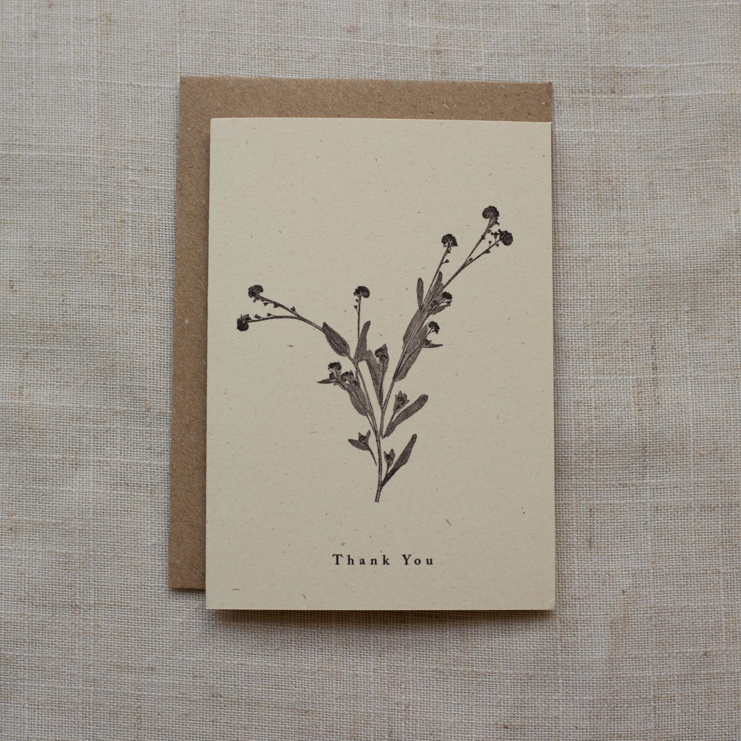 Greeting card with botanical design and 'Thank You' text on a matte surface