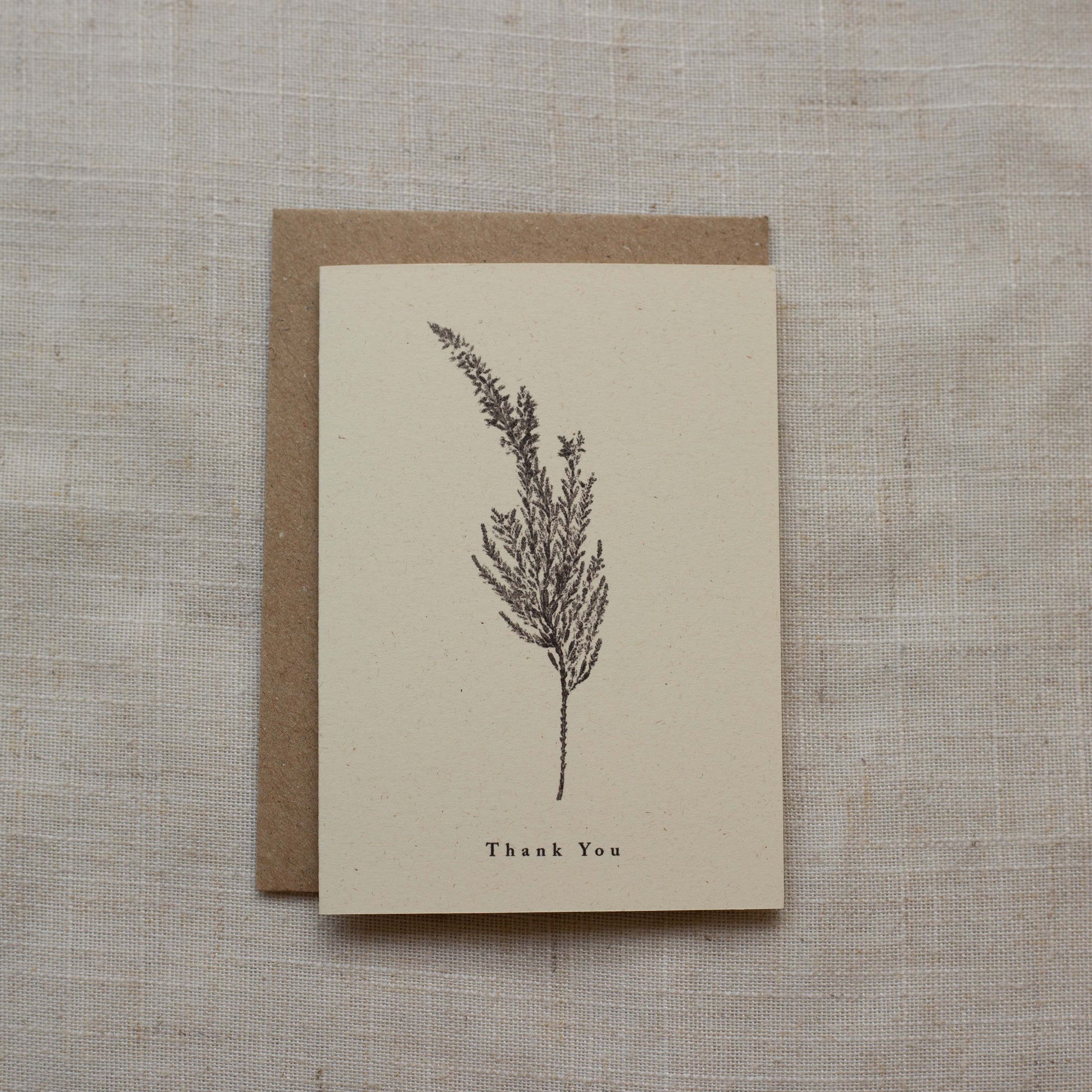 Greeting card with a plant illustration and 'Thank You' text on a textured surface