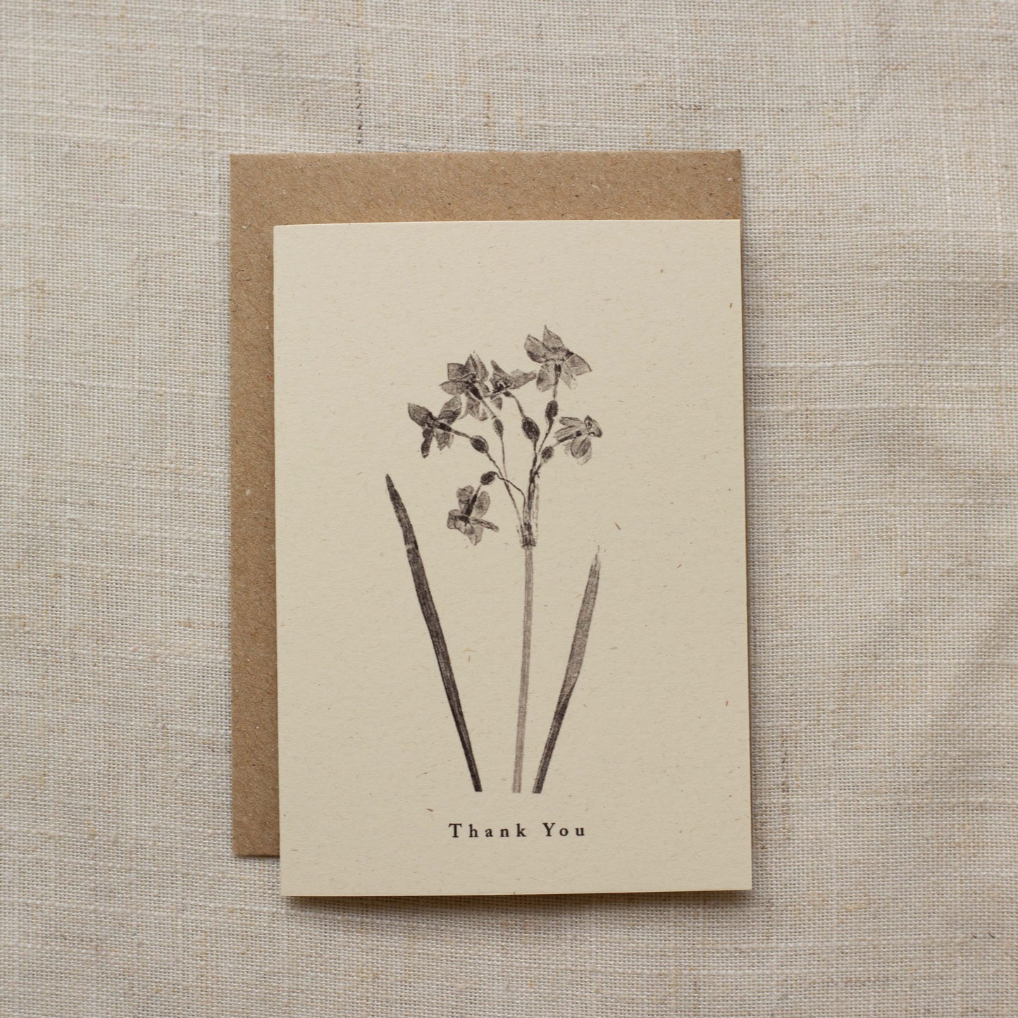 Greeting card with floral design and 'Thank You' text on a textured beige background