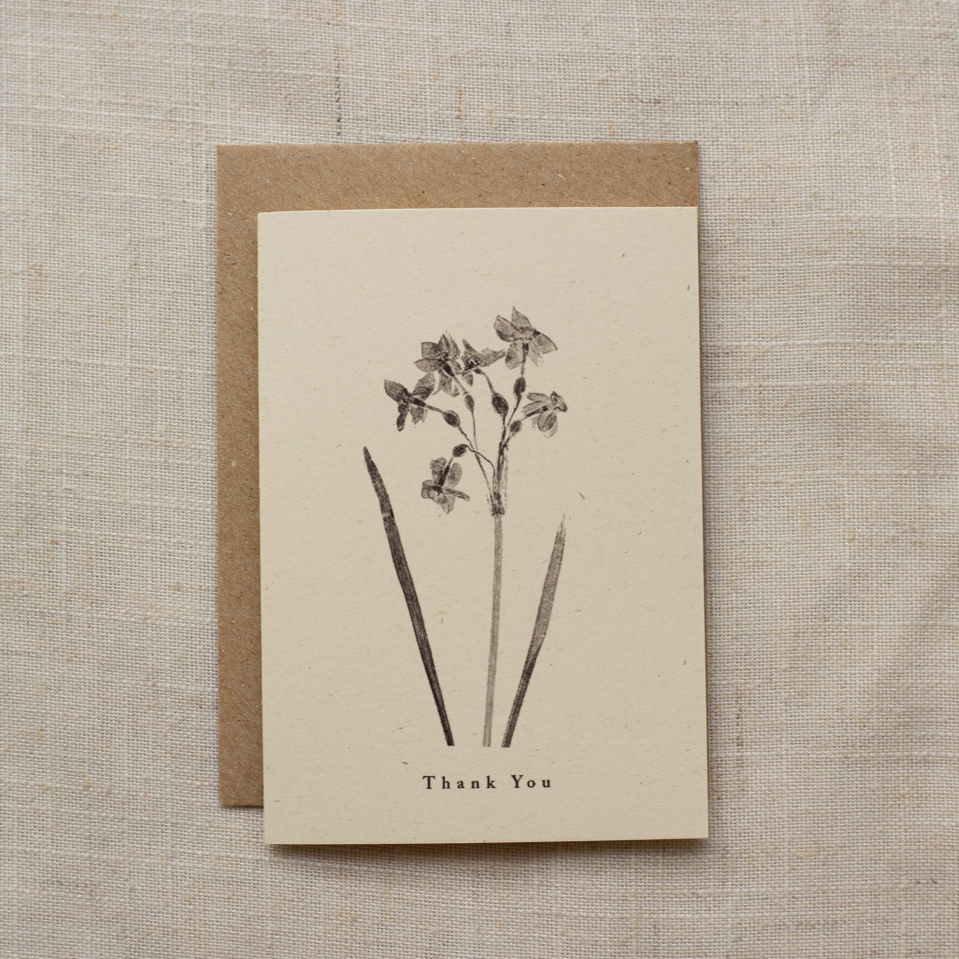 Greeting card with floral design and 'Thank You' text on a textured beige background