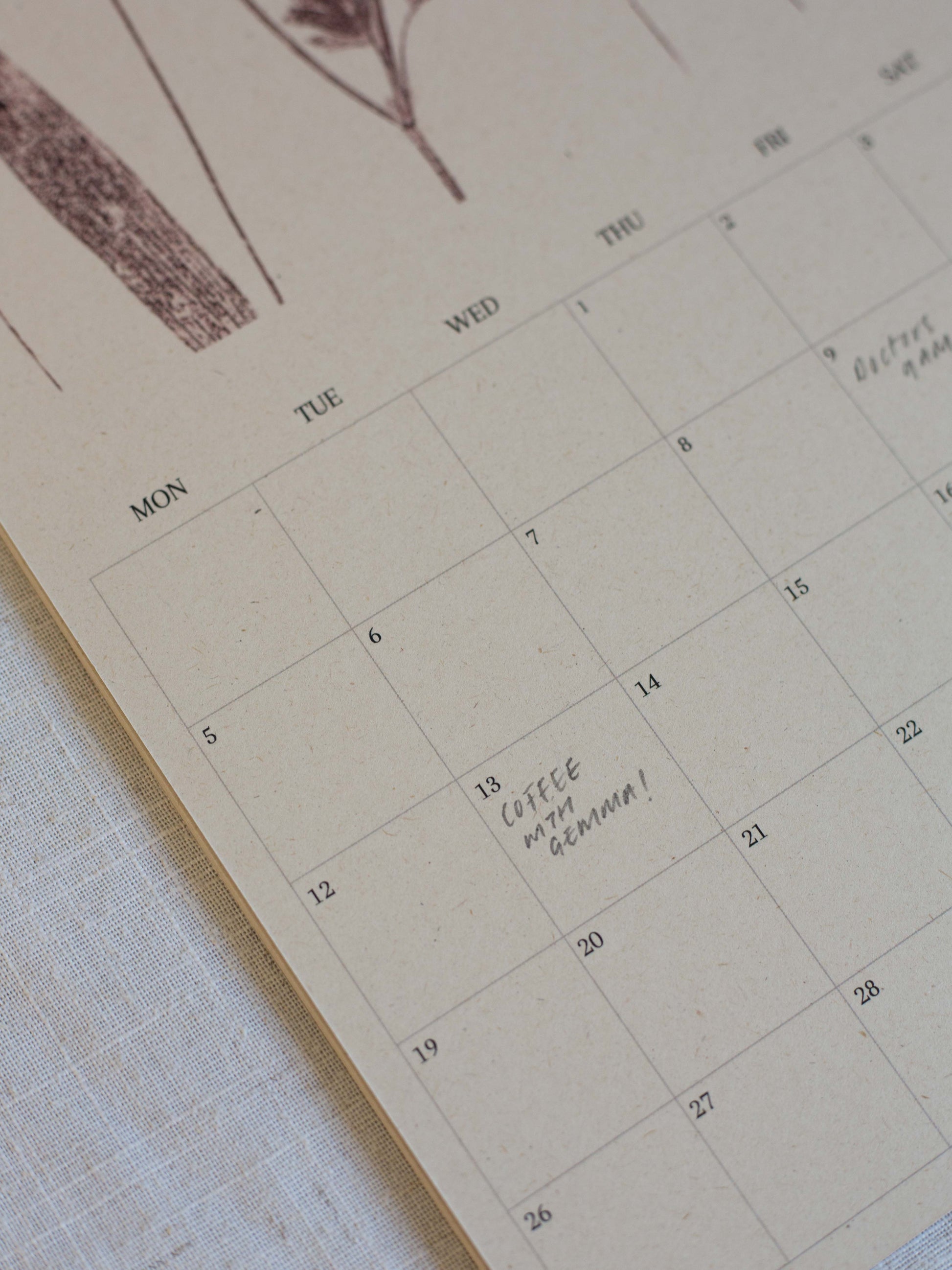 A close up of the boxes on the 2027 botanical calendar, printed on a eco friendly beige cardstock