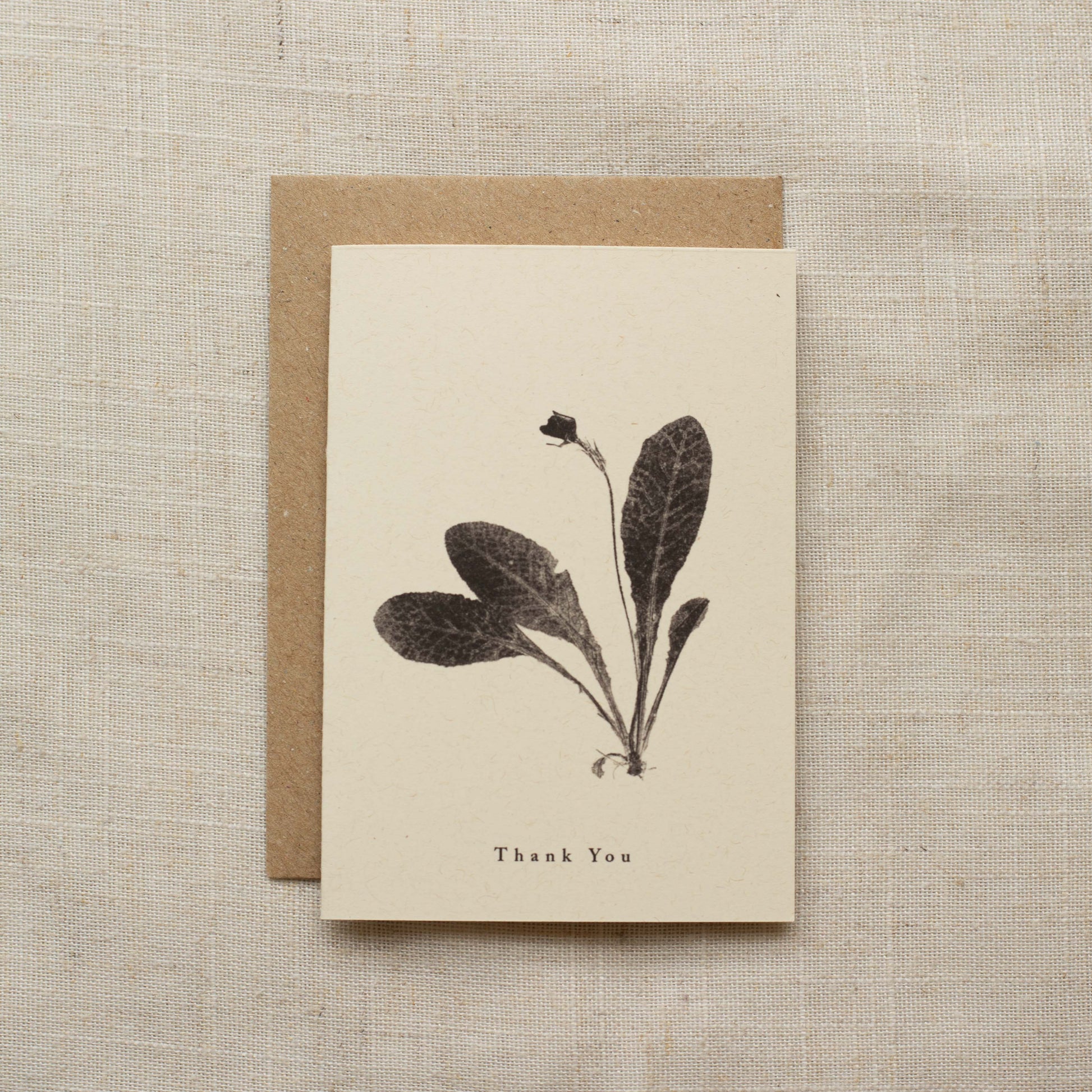 Greeting card with botanical design and 'Thank You' text on a matte beige background