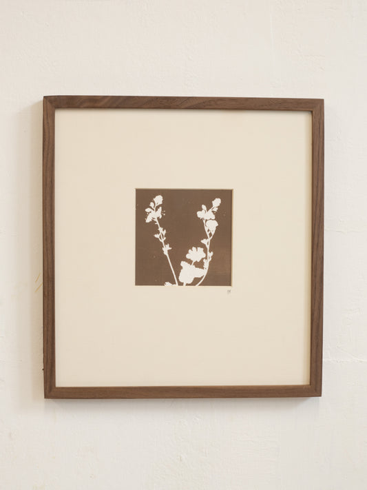 Framed artwork with floral design on a beige background